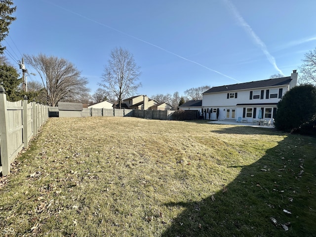 view of yard with a patio, french doors, and a fenced backyard