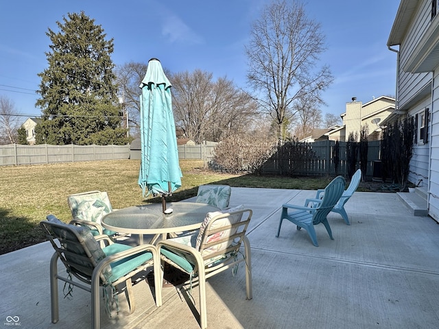 view of patio with outdoor dining space and a fenced backyard