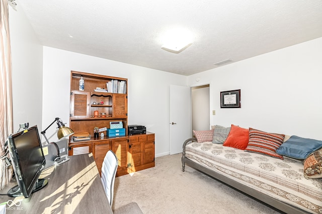 office featuring visible vents, carpet flooring, and a textured ceiling