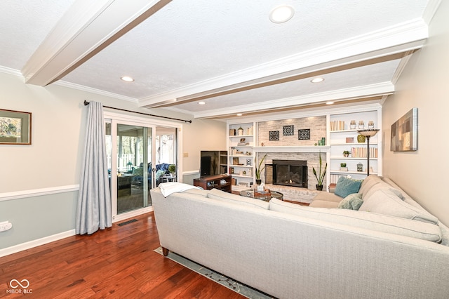 living room with dark wood finished floors, beam ceiling, crown molding, and a fireplace with raised hearth