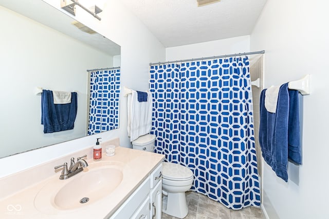 bathroom with vanity, a shower with shower curtain, toilet, and a textured ceiling