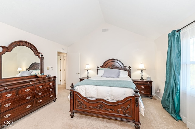 bedroom with visible vents, lofted ceiling, and light carpet