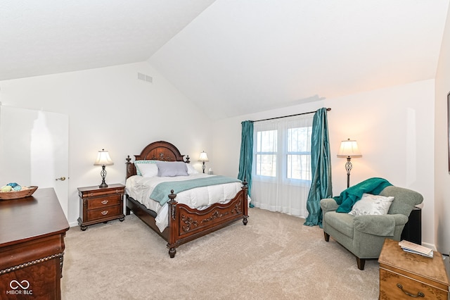 bedroom featuring lofted ceiling, light colored carpet, and visible vents