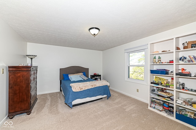 carpeted bedroom featuring baseboards and a textured ceiling