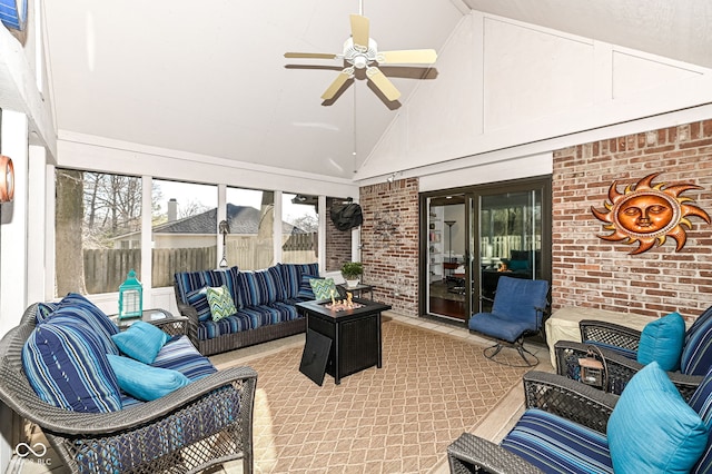 sunroom featuring vaulted ceiling and a ceiling fan