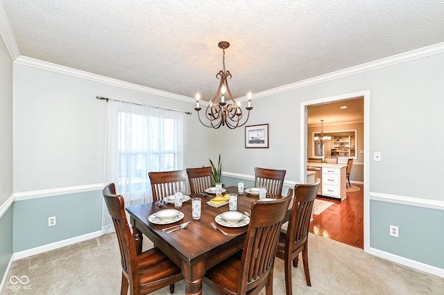 dining room with a notable chandelier, light colored carpet, and ornamental molding