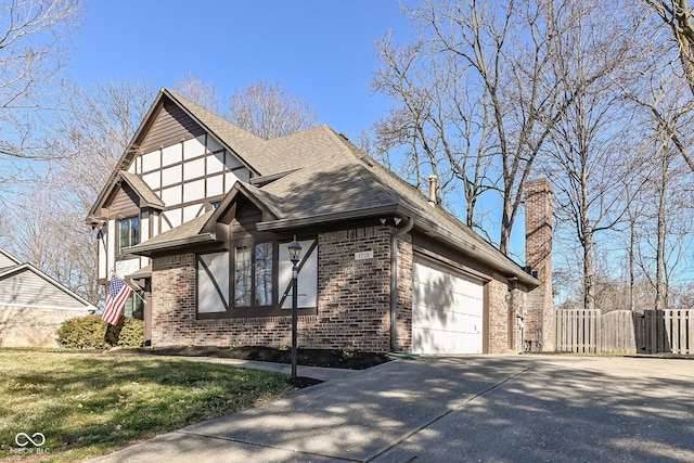 view of front of property with fence, concrete driveway, a shingled roof, brick siding, and a chimney