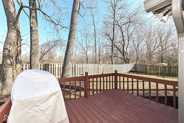 deck featuring grilling area and a fenced backyard