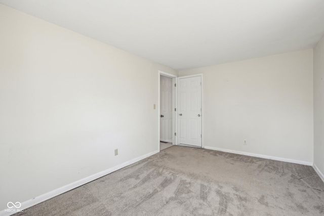 carpeted spare room with baseboards