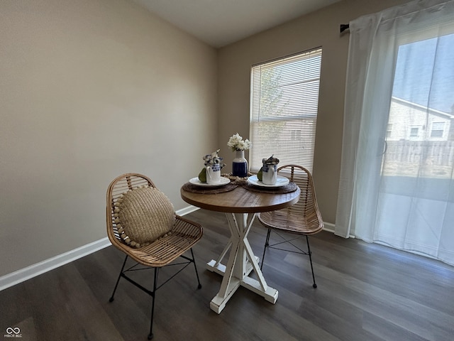 dining room featuring baseboards and wood finished floors