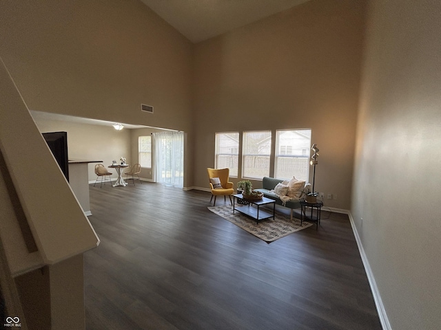 living area featuring dark wood finished floors, baseboards, and visible vents