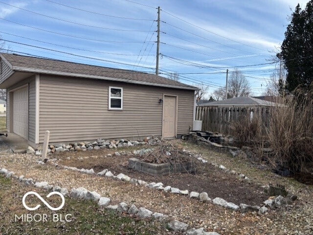 view of outbuilding featuring an outbuilding and fence