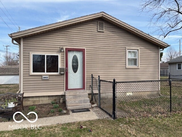 bungalow-style home with fence and entry steps