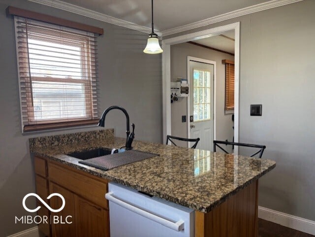 kitchen with dishwashing machine, dark stone countertops, baseboards, a sink, and crown molding