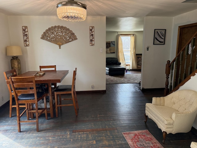 dining room with stairs, an inviting chandelier, baseboards, and wood-type flooring