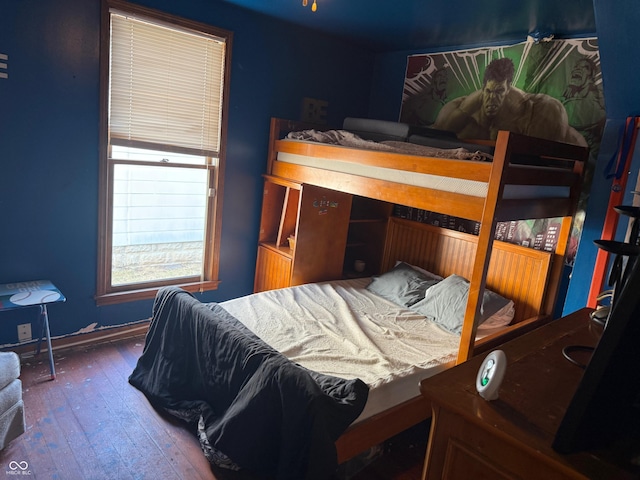 bedroom with hardwood / wood-style floors and baseboards