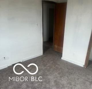 carpeted empty room with baseboards