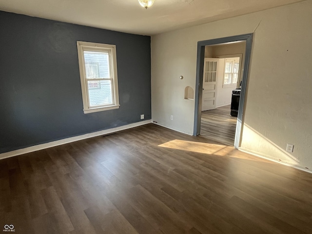 unfurnished room featuring dark wood finished floors and baseboards