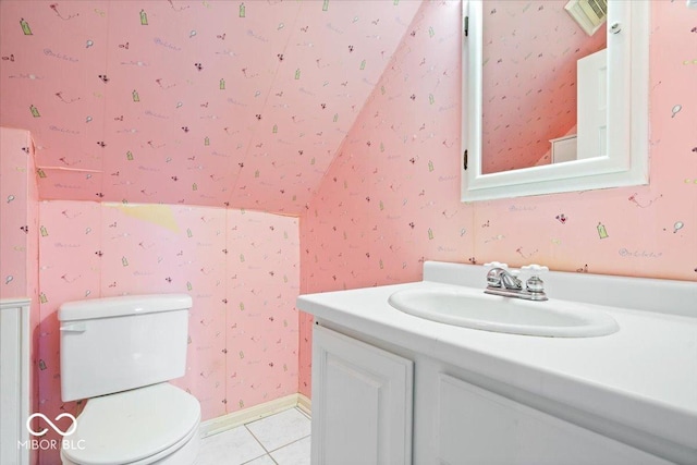 bathroom featuring tile patterned flooring, toilet, vanity, and wallpapered walls