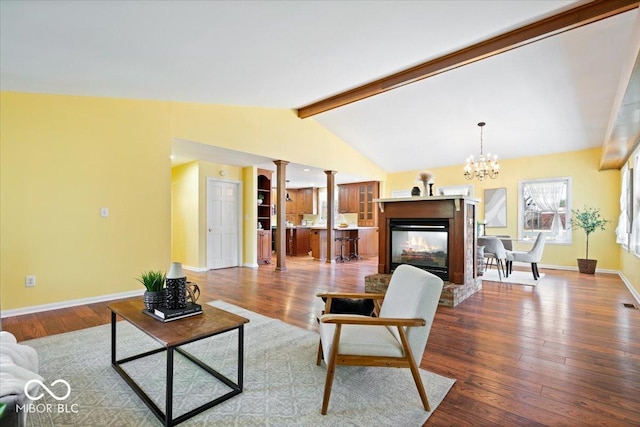 living room with hardwood / wood-style floors, baseboards, decorative columns, vaulted ceiling with beams, and a multi sided fireplace