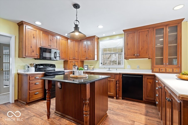 kitchen featuring recessed lighting, light wood-style floors, and black appliances