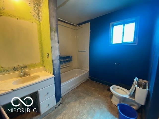 full bathroom with vanity, shower / tub combination, and toilet