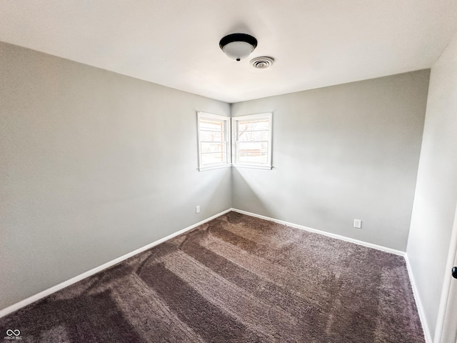 spare room with visible vents, baseboards, and carpet floors