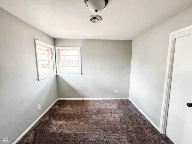 unfurnished room with visible vents, baseboards, and carpet flooring