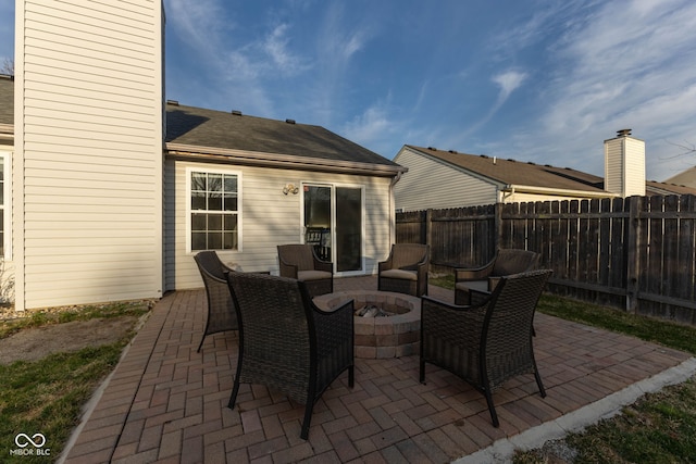 view of patio featuring fence and a fire pit