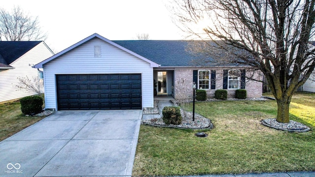 ranch-style home with a front lawn, brick siding, a garage, and driveway