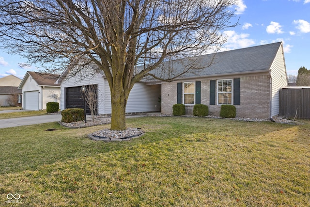 ranch-style home featuring a front yard, an attached garage, brick siding, and driveway