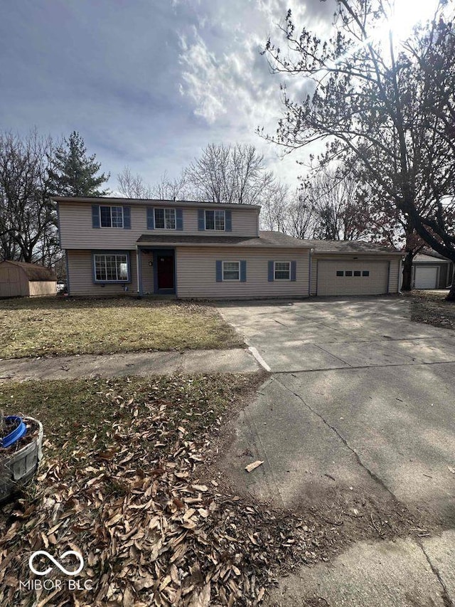 view of front of home with concrete driveway and an attached garage