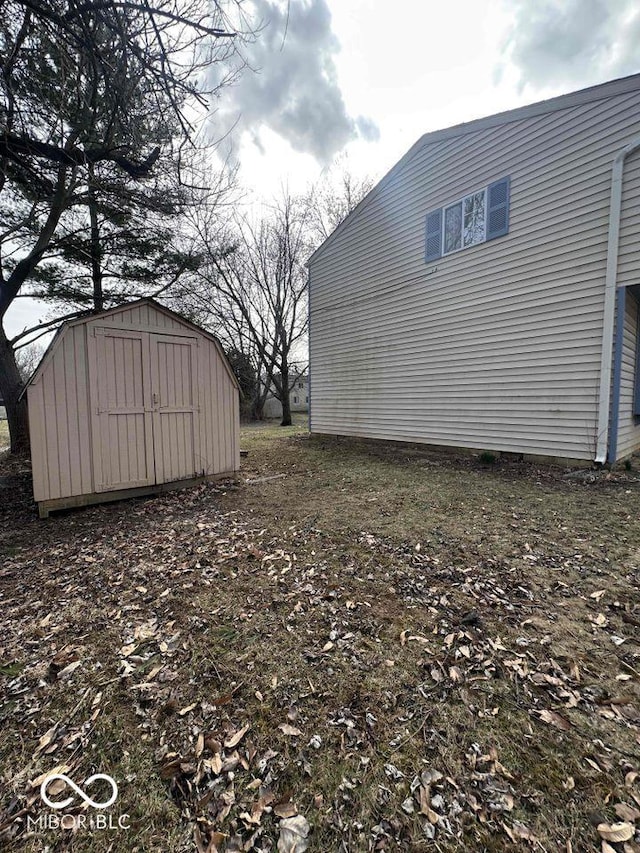 view of yard with an outbuilding and a shed