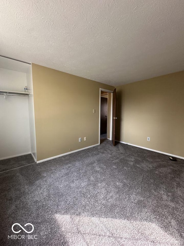 unfurnished bedroom featuring baseboards, carpet floors, and a textured ceiling