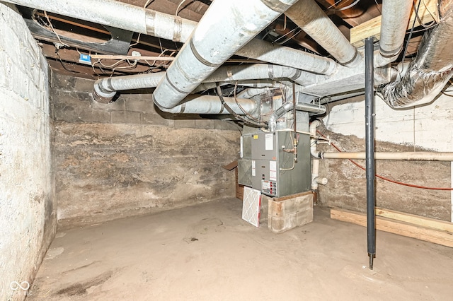 unfinished basement featuring heating unit