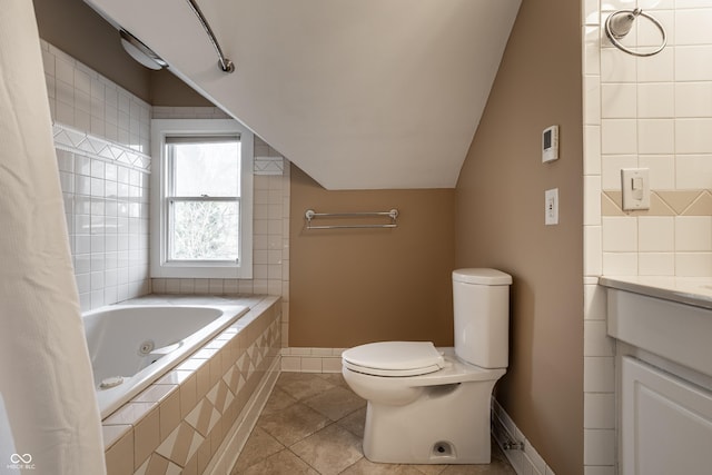 full bath featuring vanity, a tub with jets, vaulted ceiling, tile patterned floors, and toilet