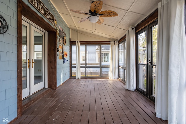 unfurnished sunroom featuring ceiling fan and vaulted ceiling