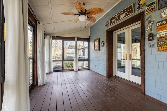 unfurnished sunroom featuring ceiling fan and vaulted ceiling