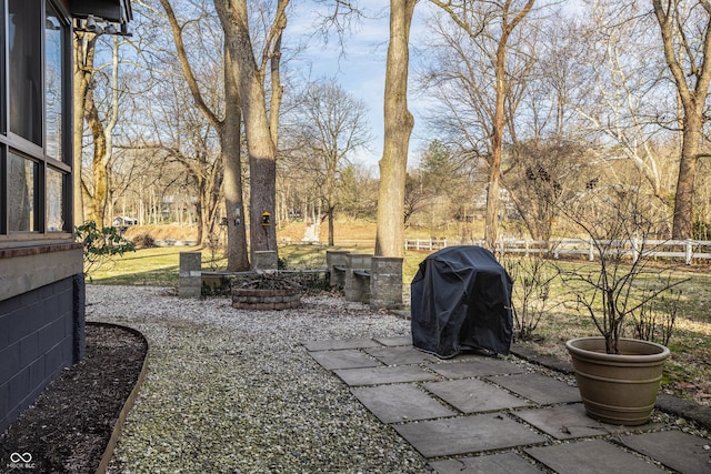 view of yard featuring a patio area, fence, and an outdoor fire pit