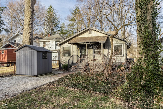 bungalow-style house with an outdoor structure and a shed