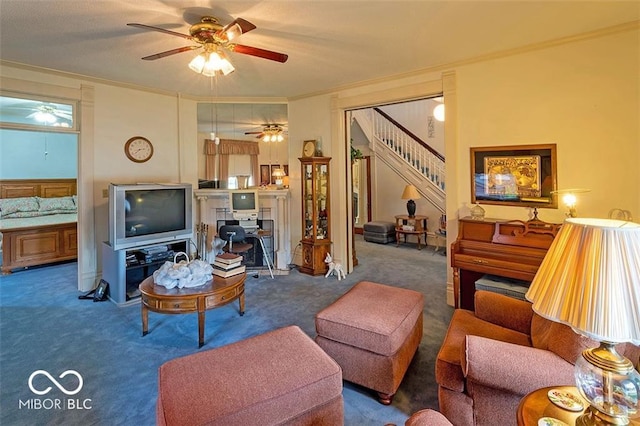 carpeted living room with crown molding, stairs, and ceiling fan