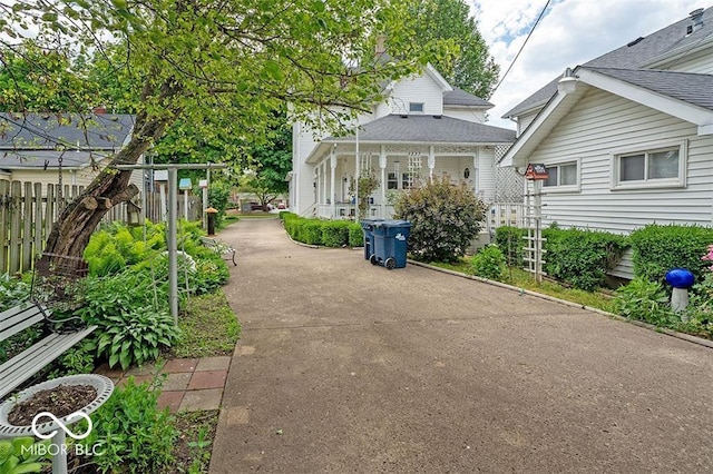 exterior space featuring concrete driveway and fence