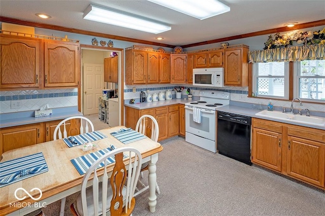 kitchen featuring white appliances, a sink, decorative backsplash, light countertops, and crown molding