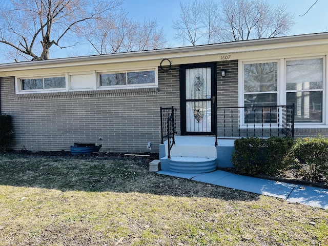 1607 Elmhurst Dr, Indianapolis, IN 46219 - view of front facade with a front lawn and brick siding