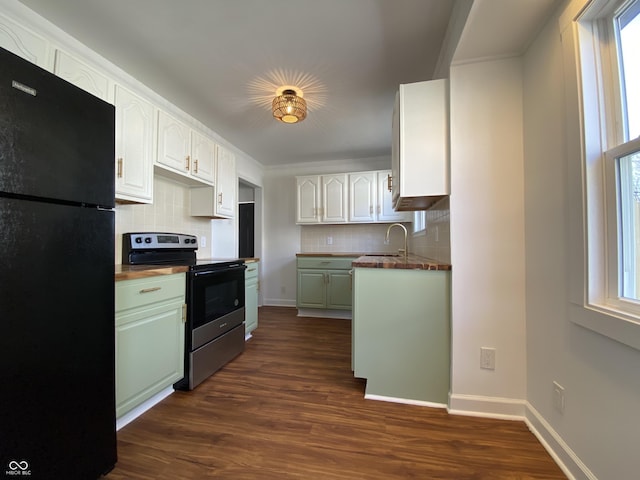 kitchen featuring plenty of natural light, stainless steel electric range, freestanding refrigerator, and dark wood-type flooring