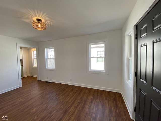 interior space featuring dark wood finished floors and baseboards