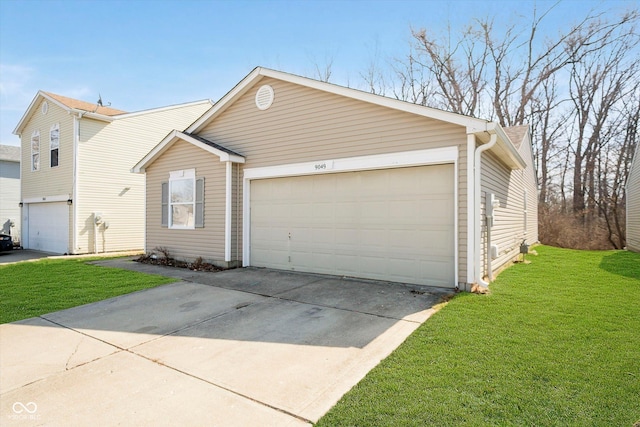 view of front of home with a front yard, concrete driveway, and a garage