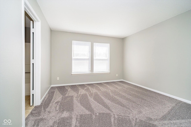 unfurnished room featuring baseboards and carpet floors