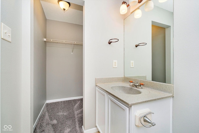 bathroom featuring baseboards and vanity