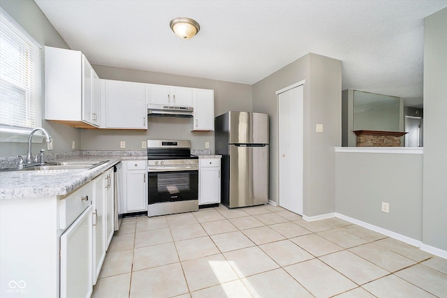 kitchen featuring a sink, light countertops, under cabinet range hood, appliances with stainless steel finishes, and white cabinetry